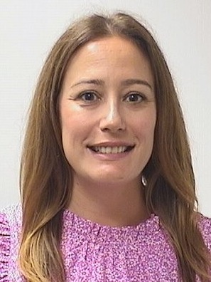 Cortney Sillery. image of a woman with a mute background and pink shirt.