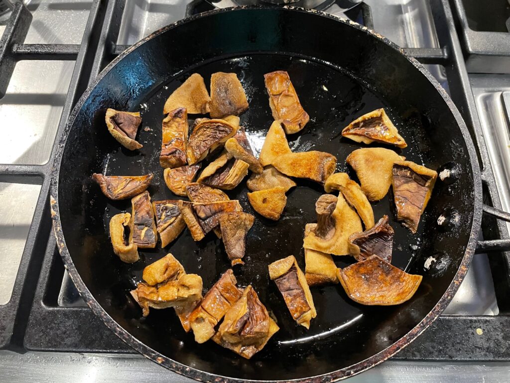 Mushrooms cooking in a frying pan